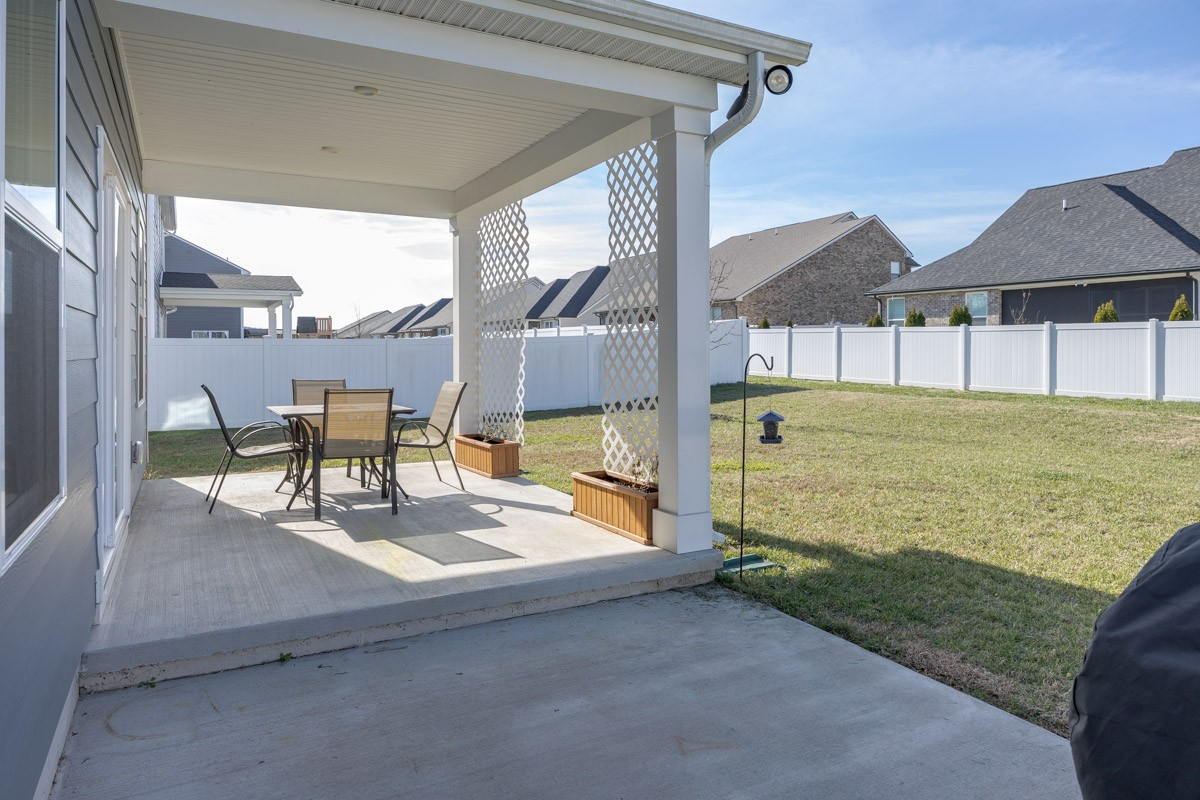 3232 Firerock Drive Murfreesboro, TN 37128 - Photo 38 of 45 a view of a patio with a table and chairs under an umbrella