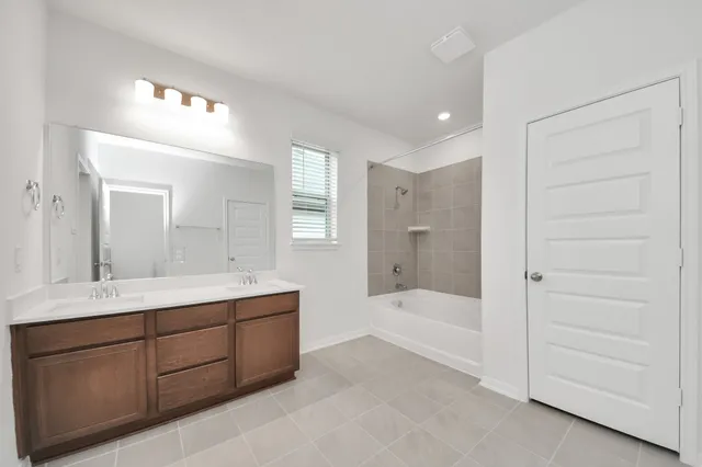 a bathroom with a double vanity sink and a mirror