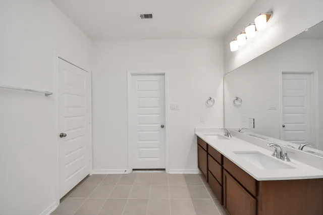 a bathroom with a tub sink and mirror