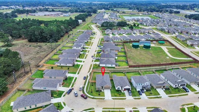 an aerial view of residential houses with outdoor space and swimming pool
