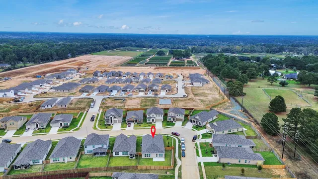 an aerial view of a house with garden space and outdoor seating