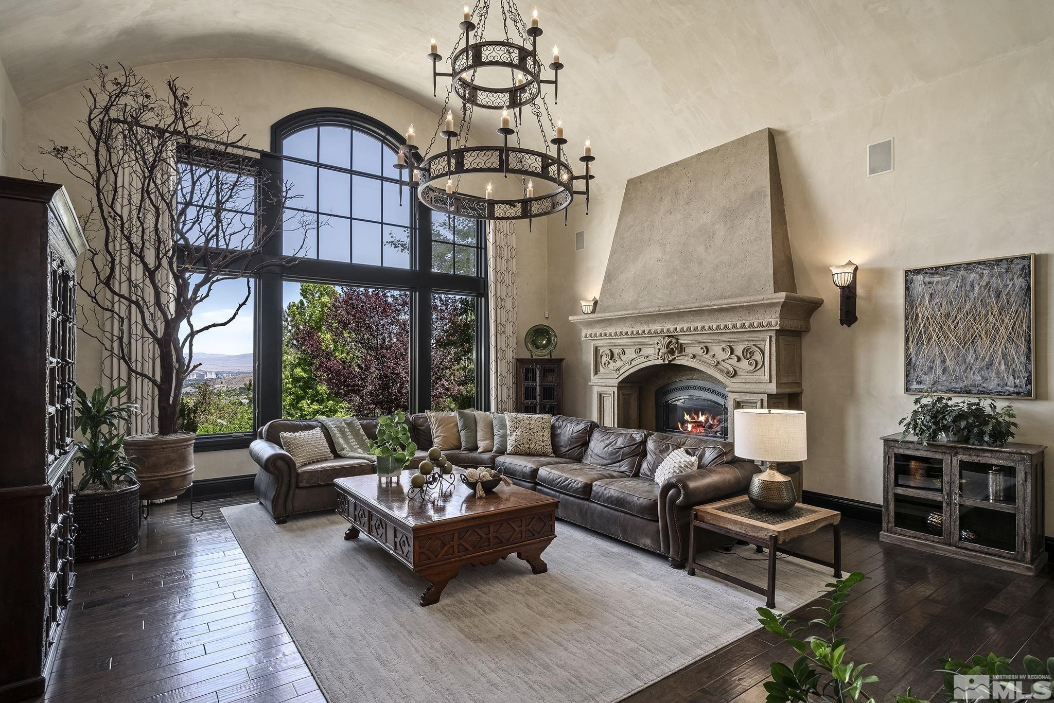 90 Hawken Road Reno, NV 89519 - Photo 12 of 40 a living room with furniture a fireplace and a chandelier
