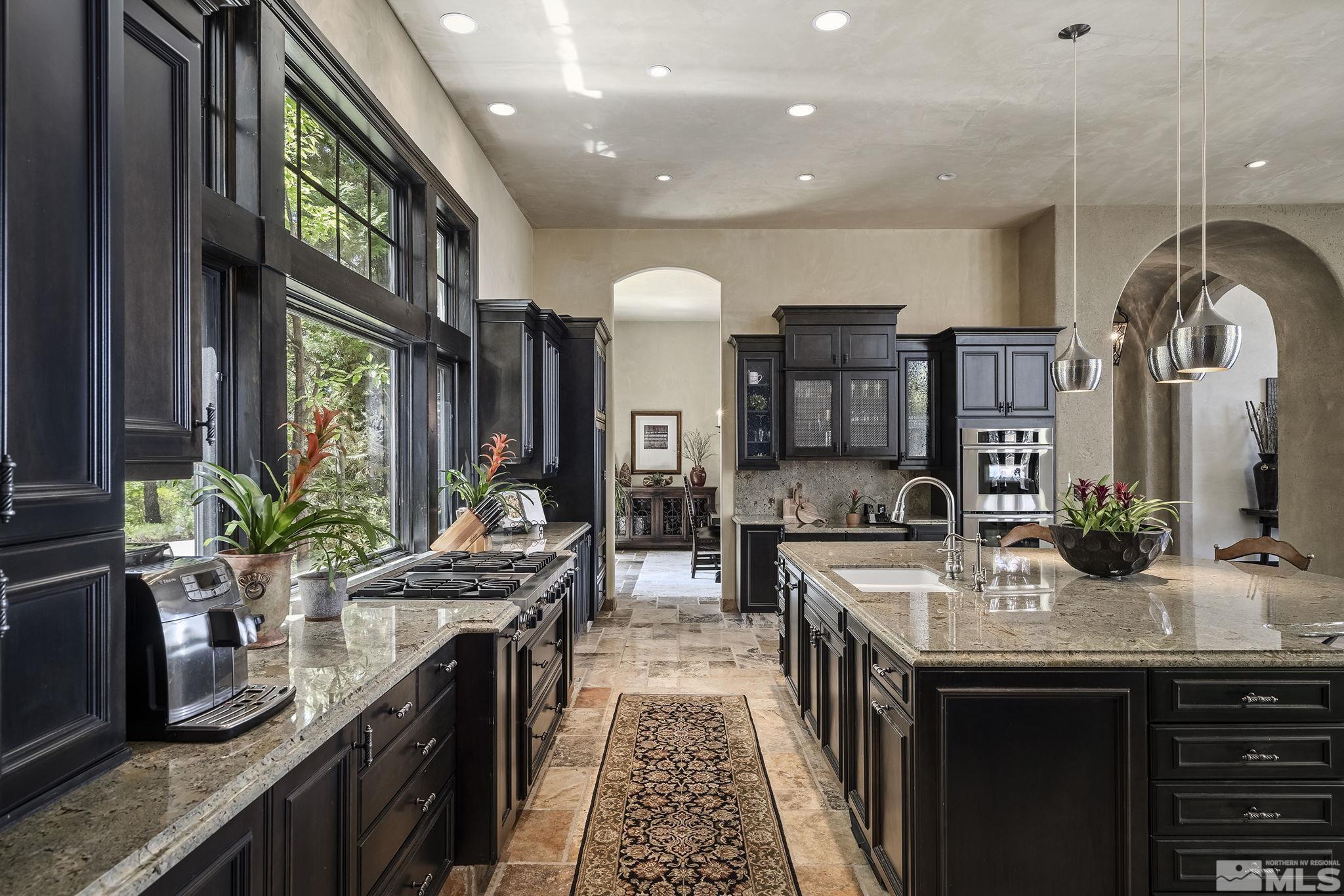 90 Hawken Road Reno, NV 89519 - Photo 14 of 40 a kitchen with stainless steel appliances granite countertop a stove a sink and a refrigerator