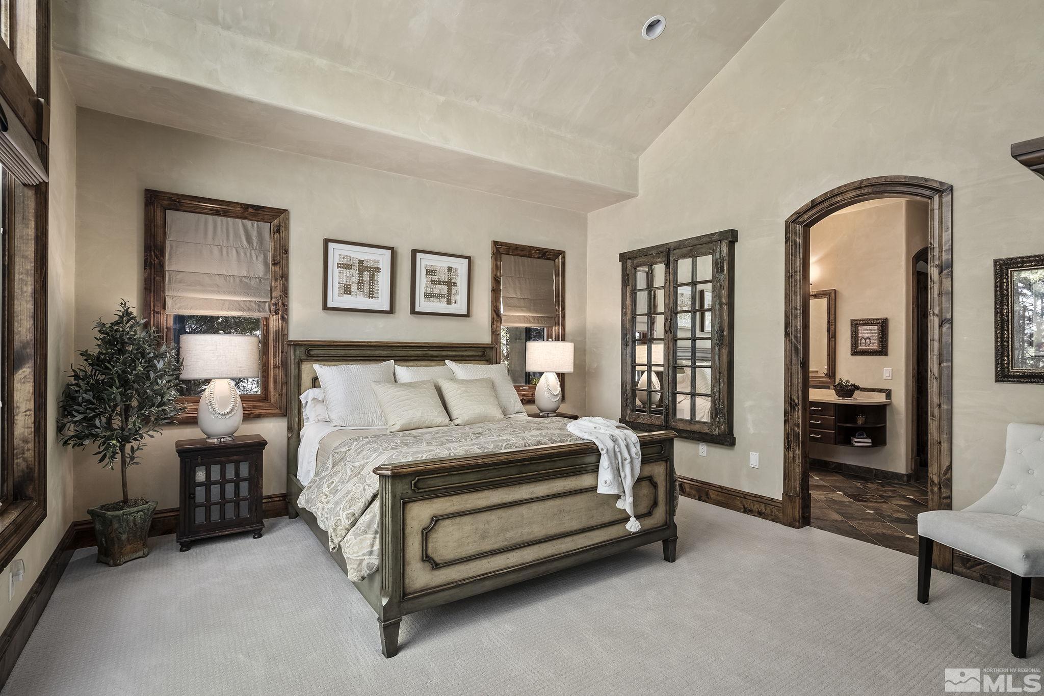 90 Hawken Road Reno, NV 89519 - Photo 25 of 40 a spacious bedroom with a bed and a couch