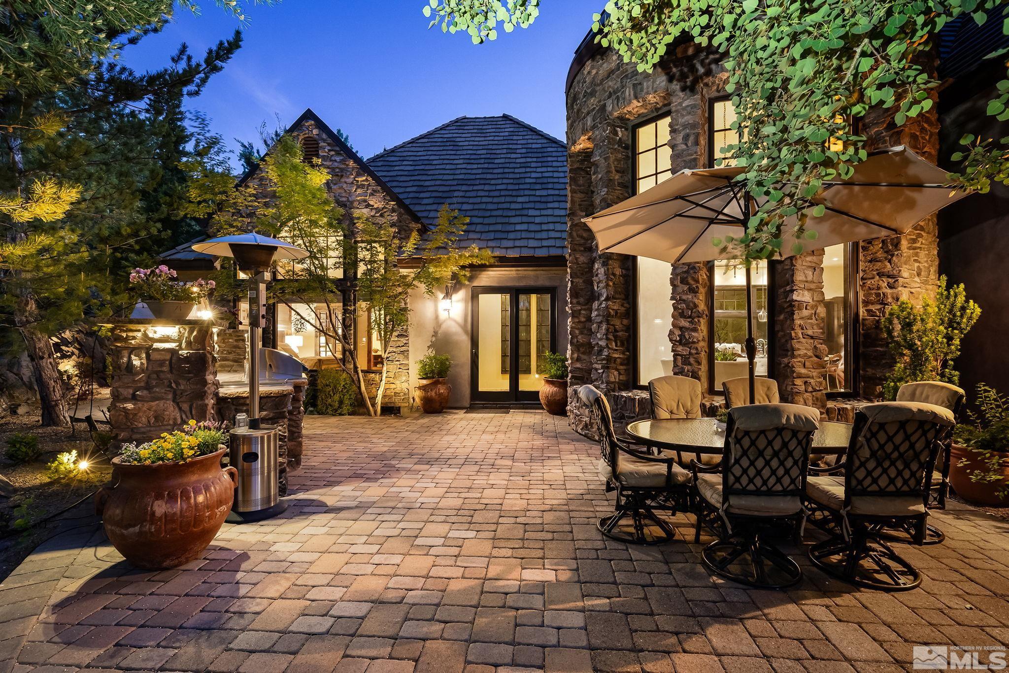 90 Hawken Road Reno, NV 89519 - Photo 31 of 40 a patio with a table and chairs and potted plants