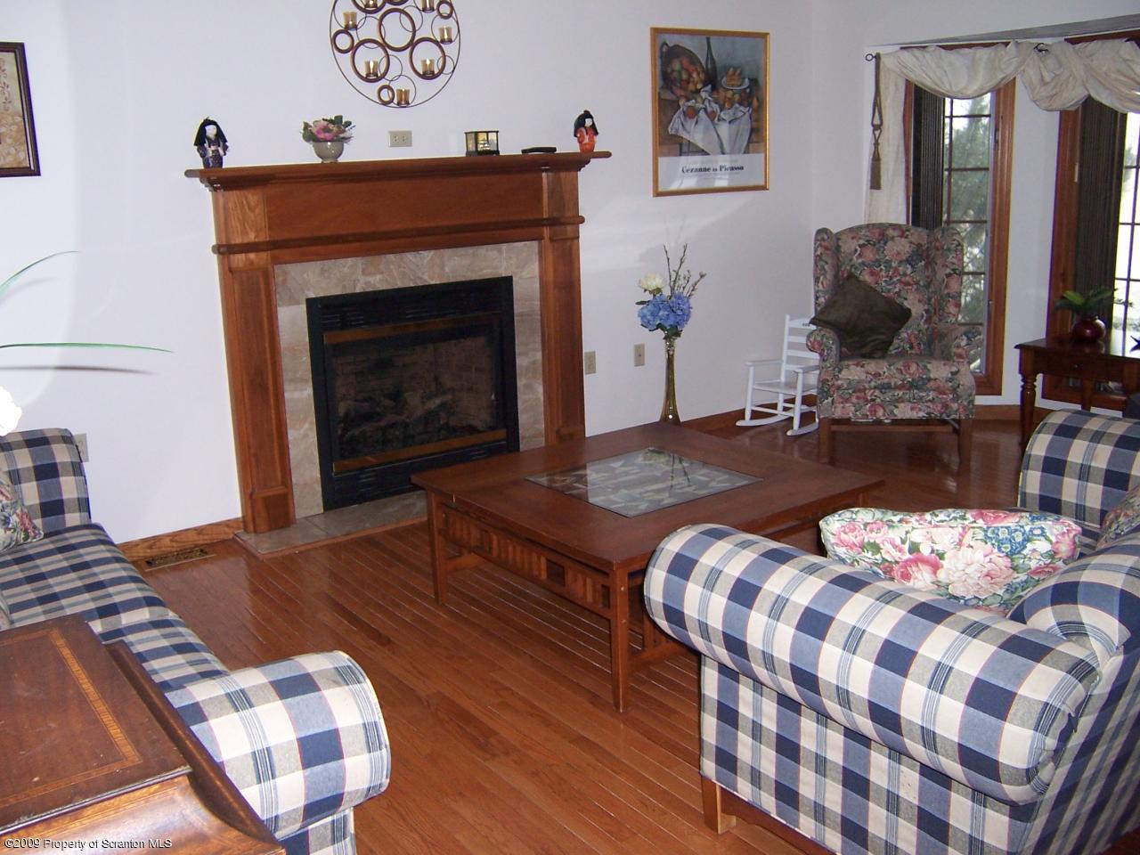 1915 Newton Ransom Boulevard Clarks Summit, PA 18411 - Photo 2 of 8 a bedroom with a bed and wooden floor