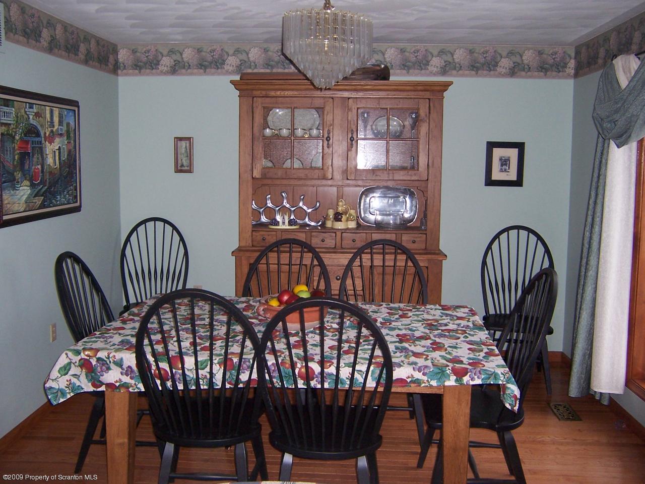 1915 Newton Ransom Boulevard Clarks Summit, PA 18411 - Photo 3 of 8 a view of a dining room with furniture and wooden floor