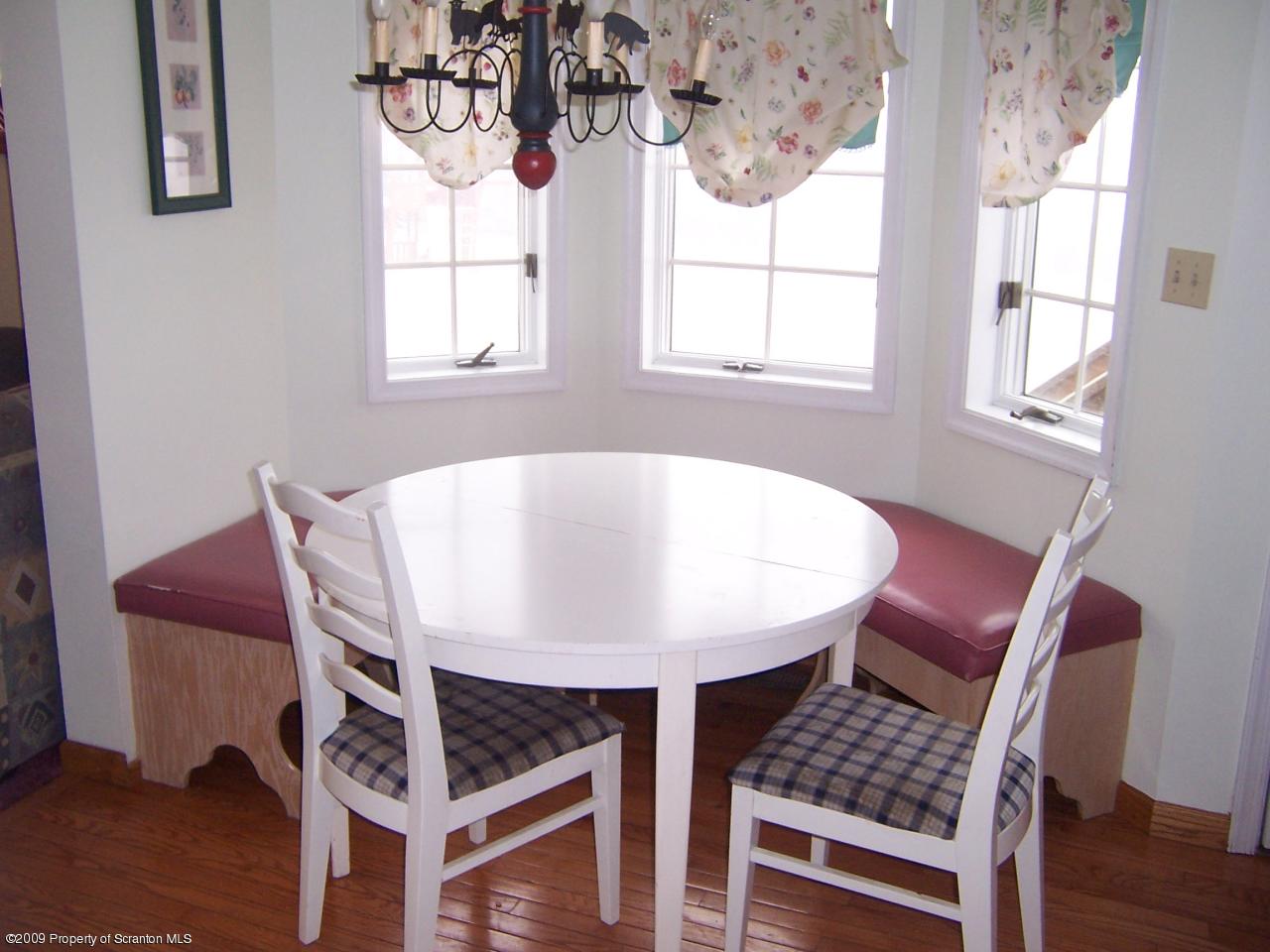 1915 Newton Ransom Boulevard Clarks Summit, PA 18411 - Photo 4 of 8 a view of a dining room with furniture window and wooden floor