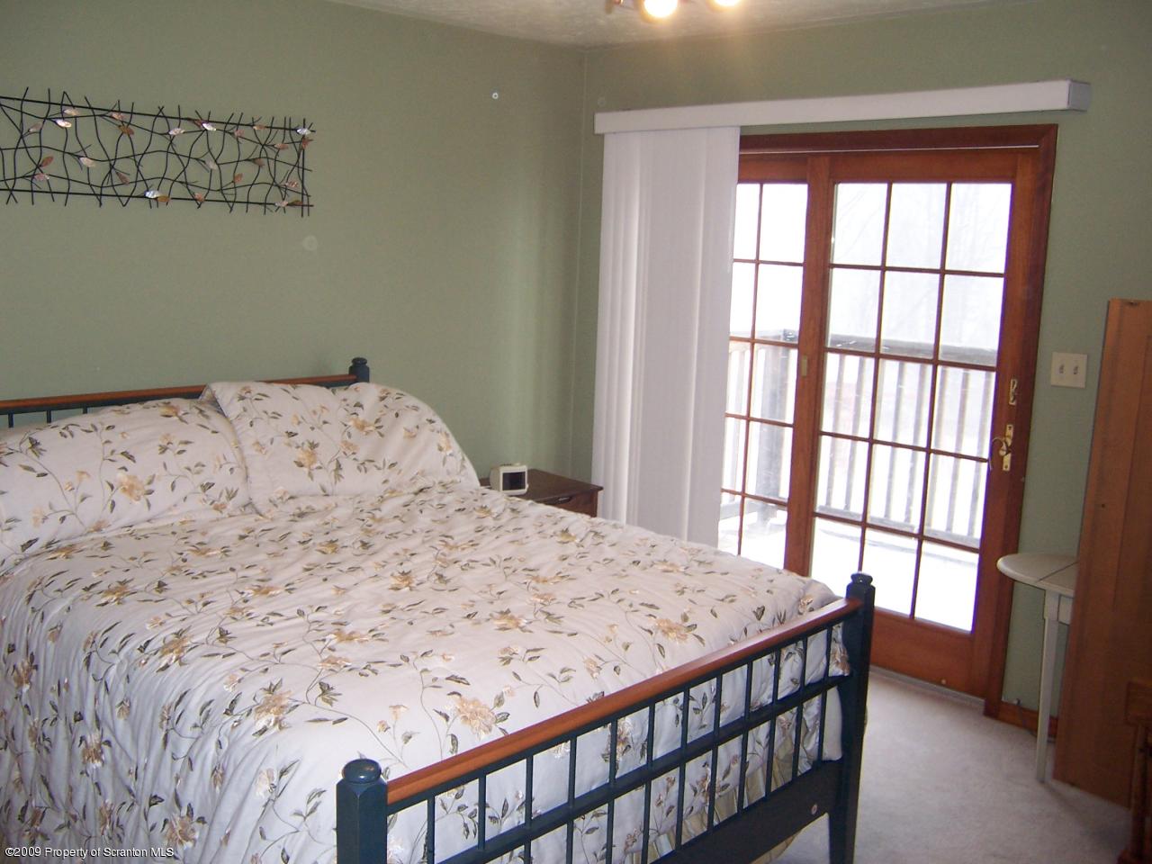 1915 Newton Ransom Boulevard Clarks Summit, PA 18411 - Photo 5 of 8 a bedroom with a bed and a window