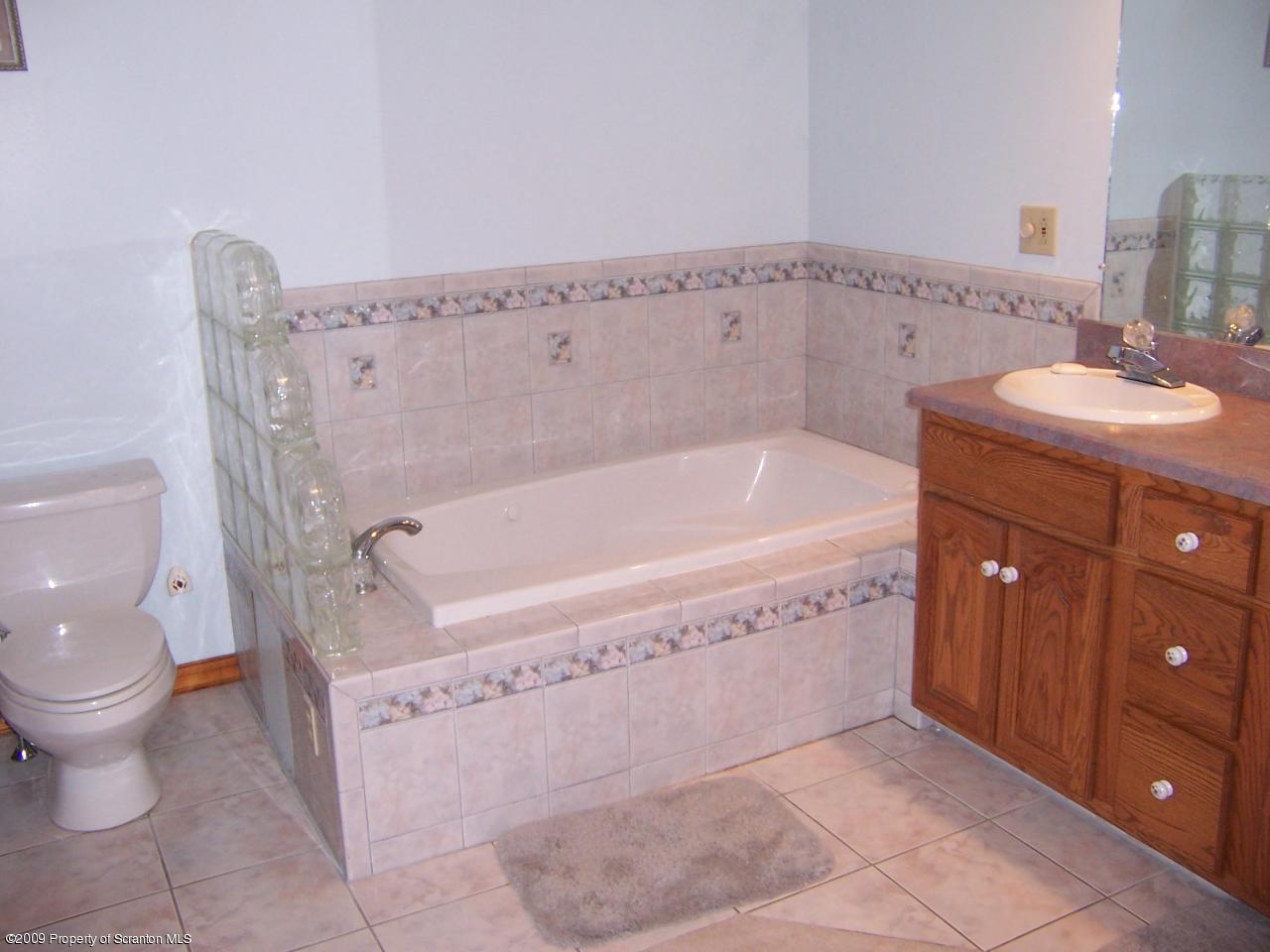 1915 Newton Ransom Boulevard Clarks Summit, PA 18411 - Photo 6 of 8 a spacious bathroom with a bathtub sink and toilet