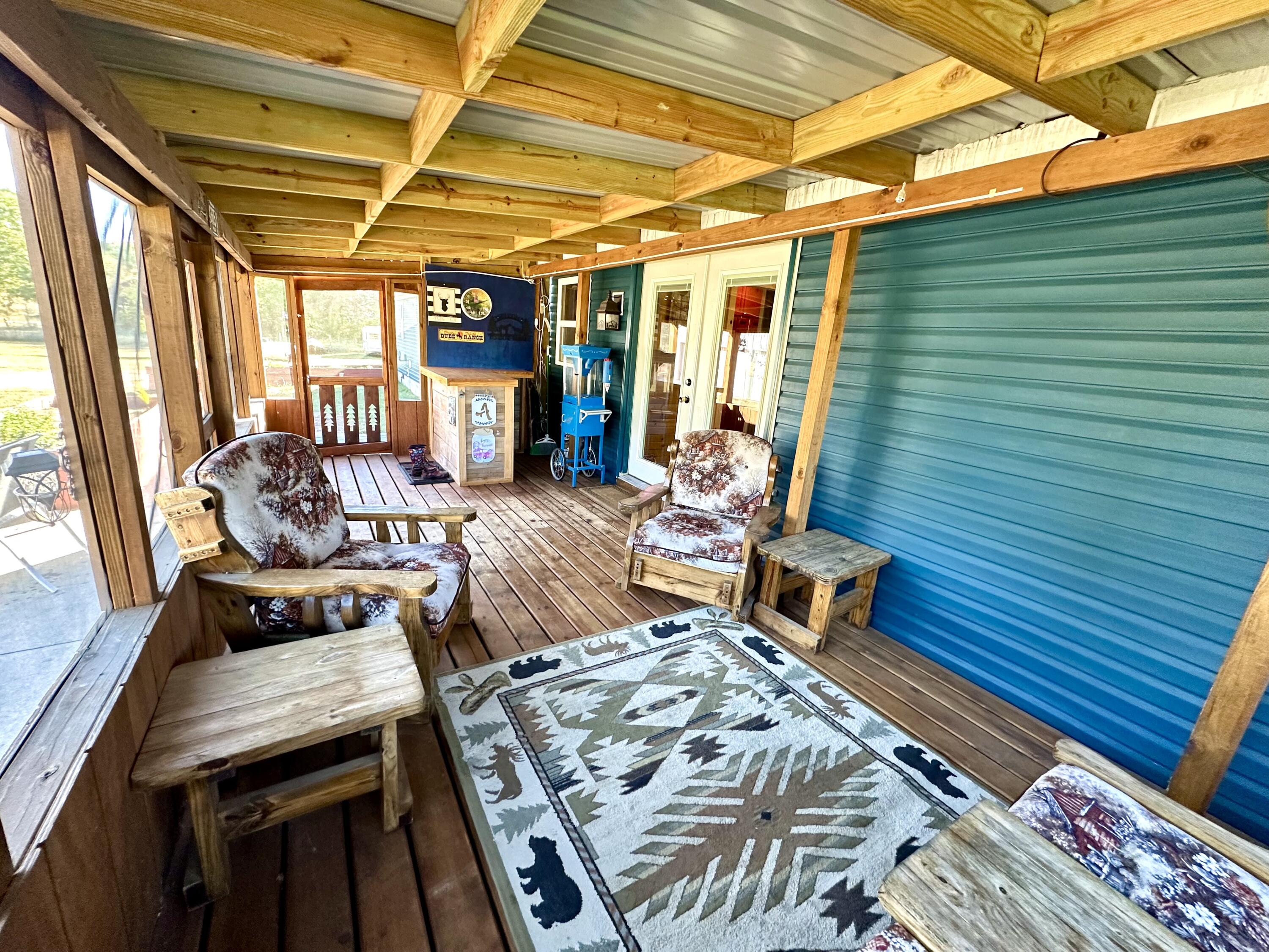 10225 Summit City Road Kingsley, MI 49649 - Photo 34 of 60 Exterior screened porch