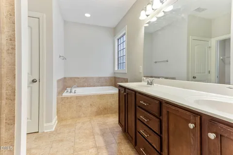 an empty room with a window and a ceiling fan