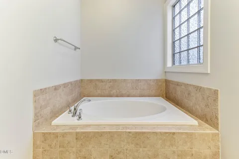 an empty room with chandelier fan