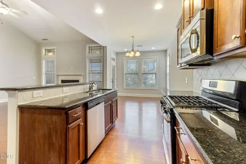 a view of kitchen with cabinets and wooden floor