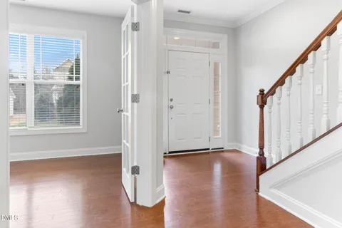 a view of an entryway with wooden floor