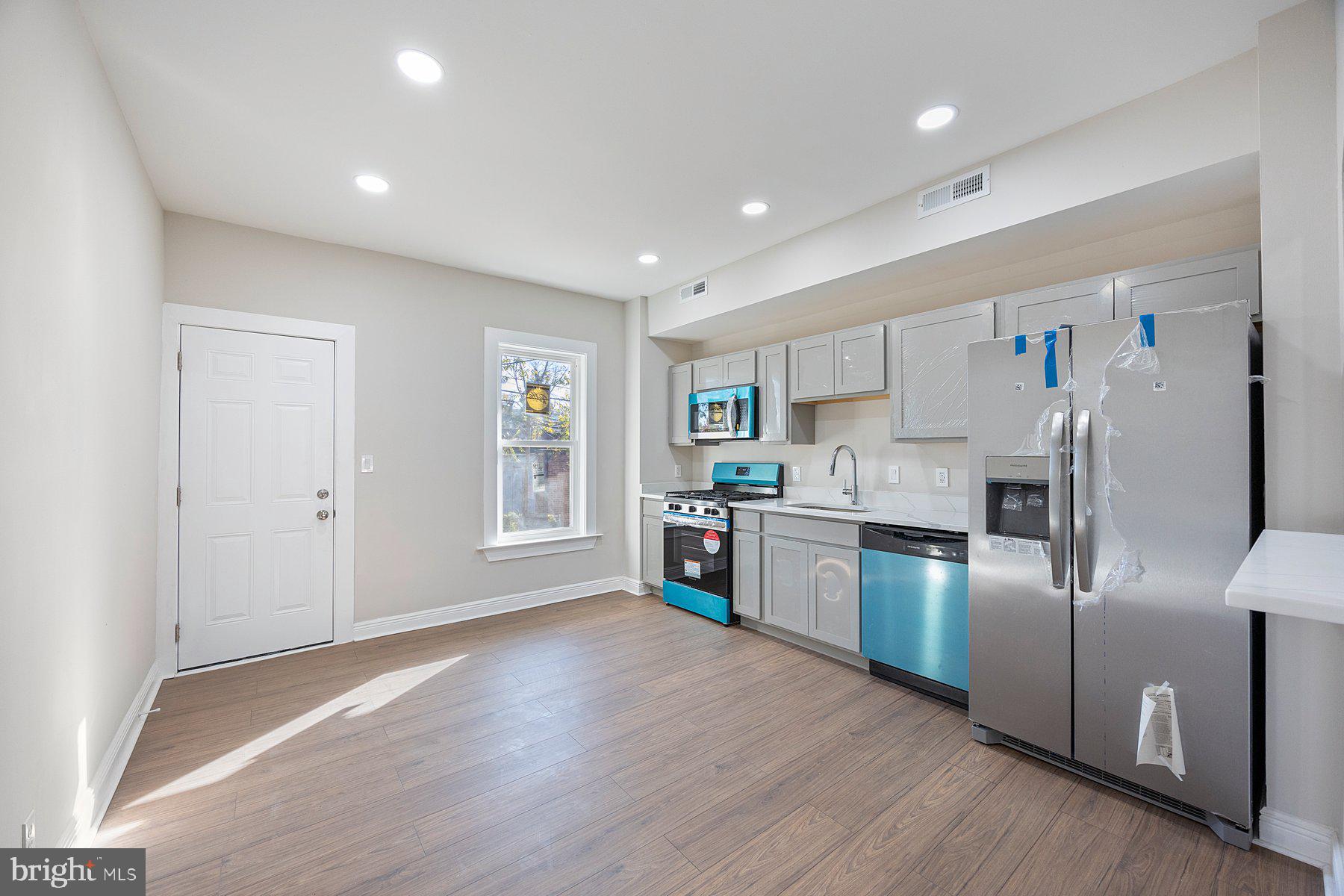 117 Collins Avenue Baltimore, MD 21229 - Photo 8 of 27 a kitchen with stainless steel appliances granite countertop a refrigerator sink and microwave