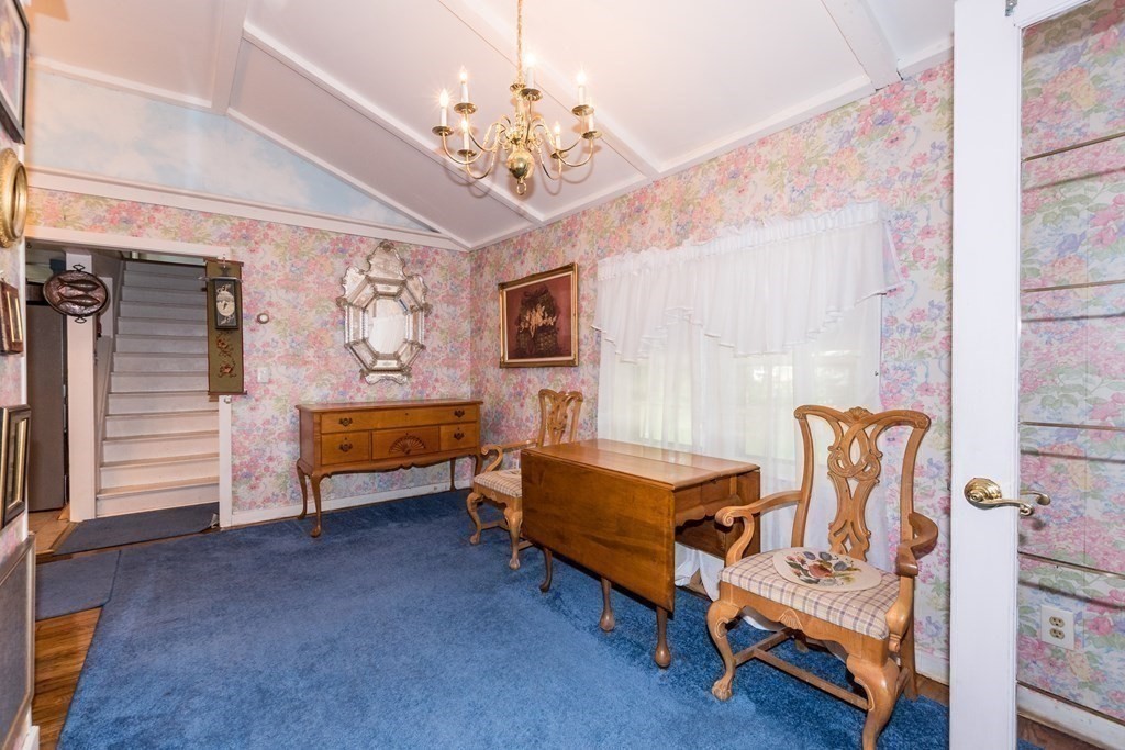1371 Broadway Hanover, MA 02339 - Photo 11 of 24 a bedroom with furniture and a chandelier