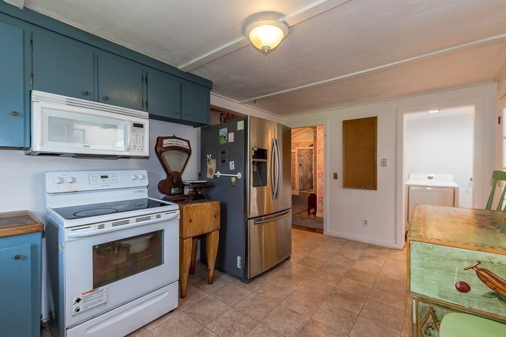 1371 Broadway Hanover, MA 02339 - Photo 13 of 24 a kitchen with refrigerator stove and microwave