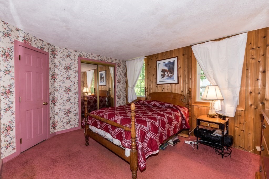 1371 Broadway Hanover, MA 02339 - Photo 17 of 24 a bed sitting in a bedroom next to a window