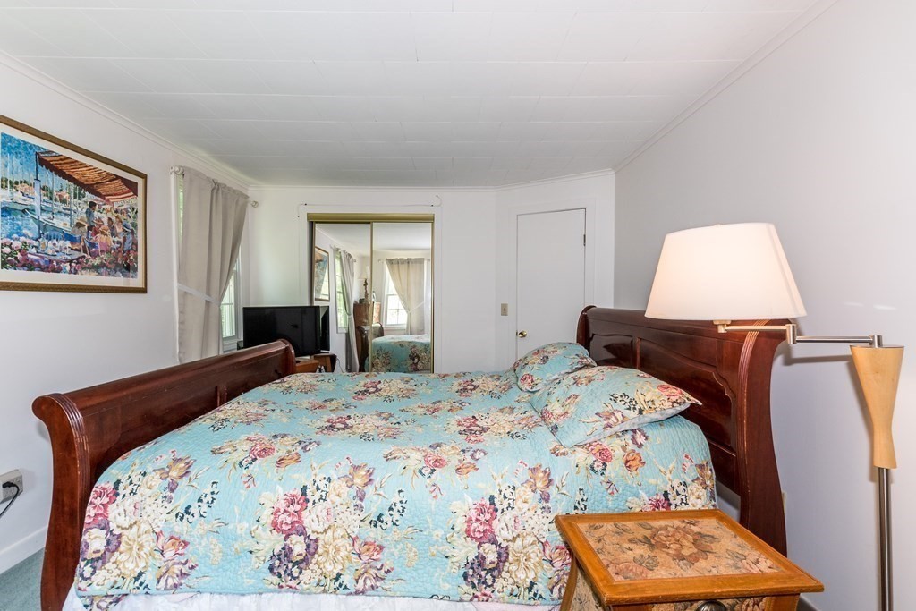 1371 Broadway Hanover, MA 02339 - Photo 21 of 24 a bedroom with a bed and a dresser in it