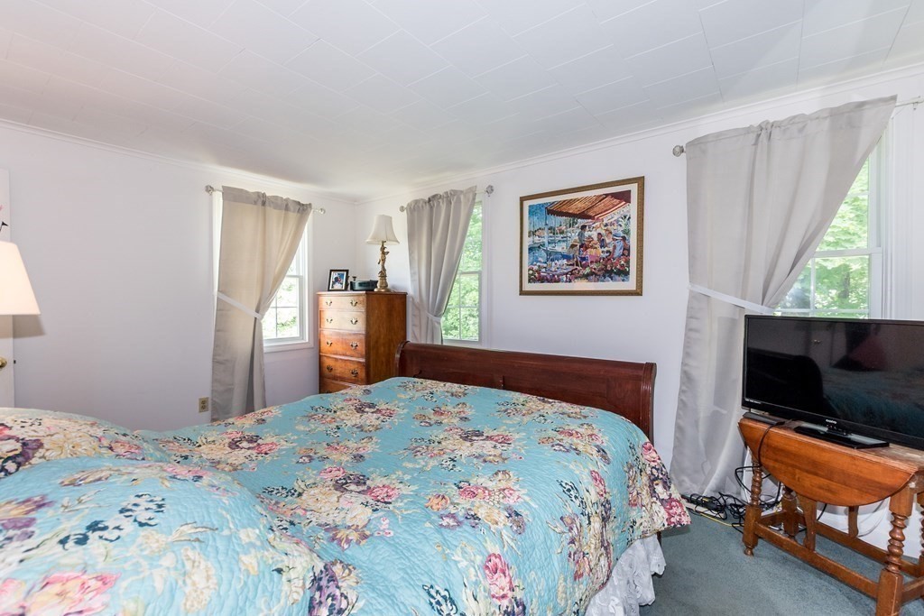1371 Broadway Hanover, MA 02339 - Photo 22 of 24 a bedroom with a bed and a flat screen tv