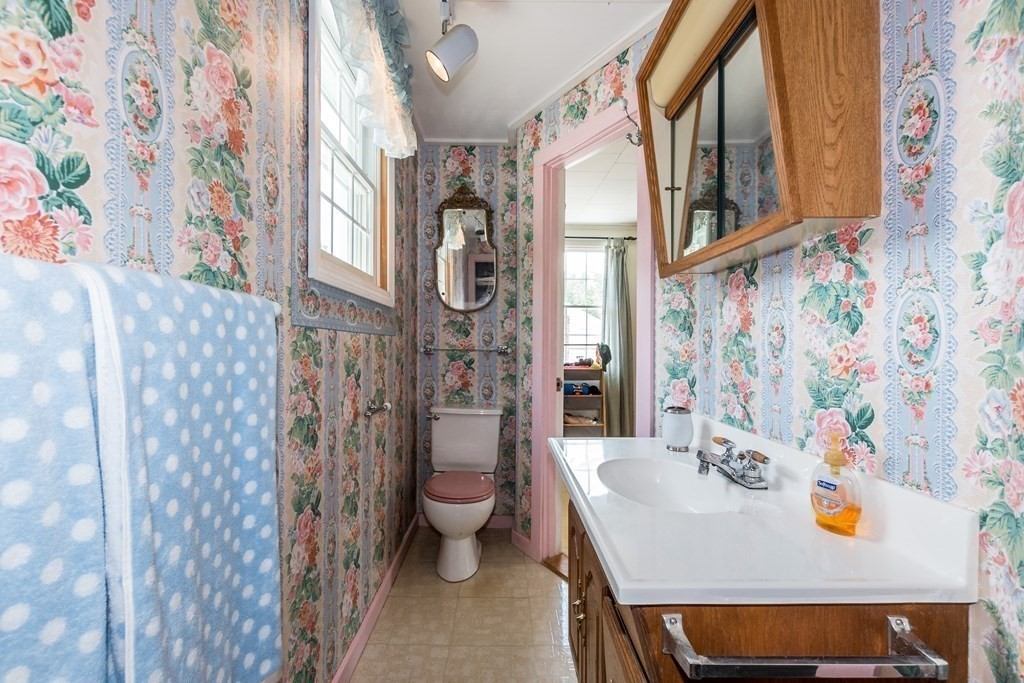 1371 Broadway Hanover, MA 02339 - Photo 23 of 24 a bathroom with a sink and mirror with toilet