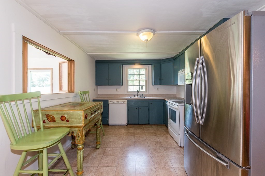 1371 Broadway Hanover, MA 02339 - Photo 3 of 24 a kitchen with a refrigerator and a stove top oven
