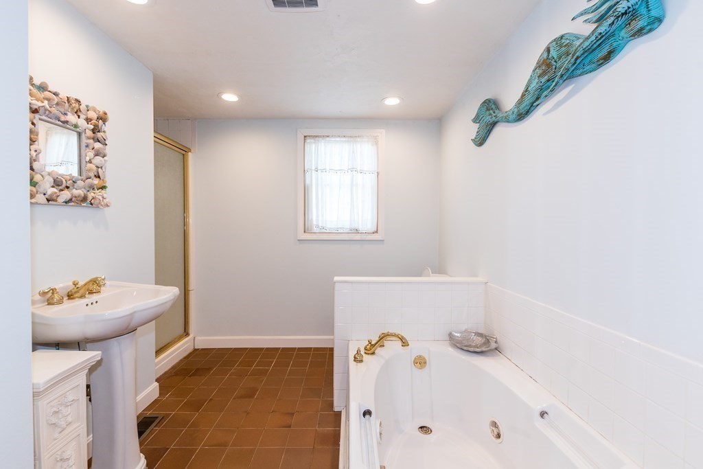 1371 Broadway Hanover, MA 02339 - Photo 5 of 24 a bathroom with a tub sink and mirror