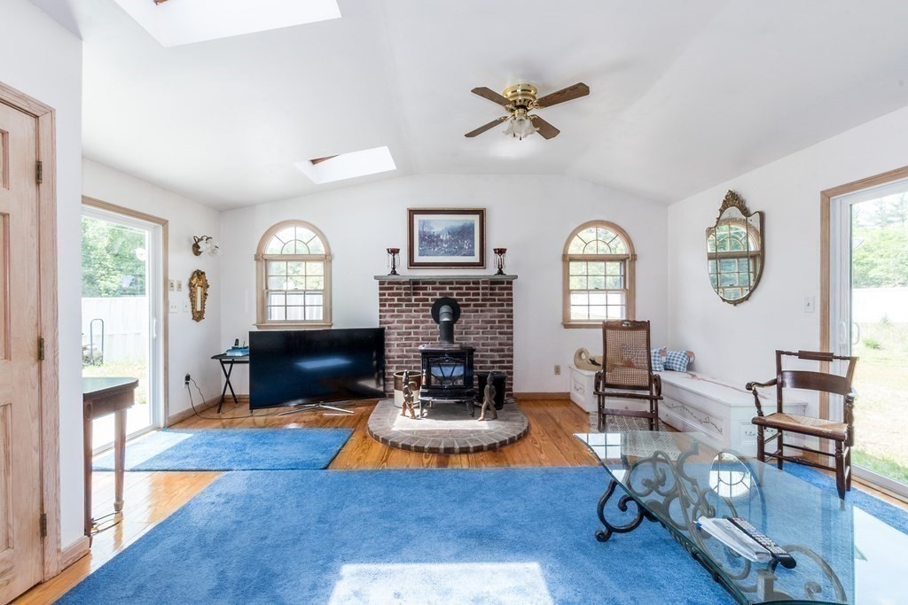 1371 Broadway Hanover, MA 02339 - Photo 6 of 24 a living room with furniture a fireplace and wooden floor