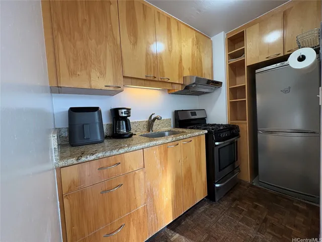 a kitchen with stainless steel appliances granite countertop a refrigerator sink and cabinets