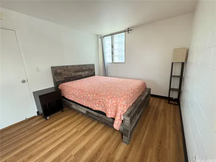 a bedroom with a bed lamp and a dresser