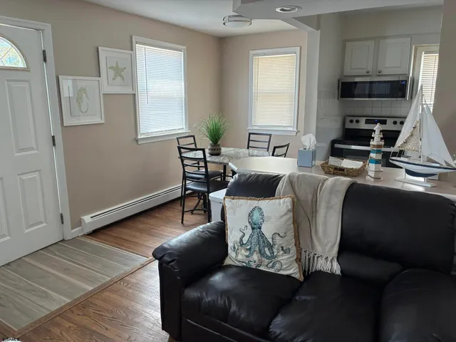 a living room with furniture fireplace and a window