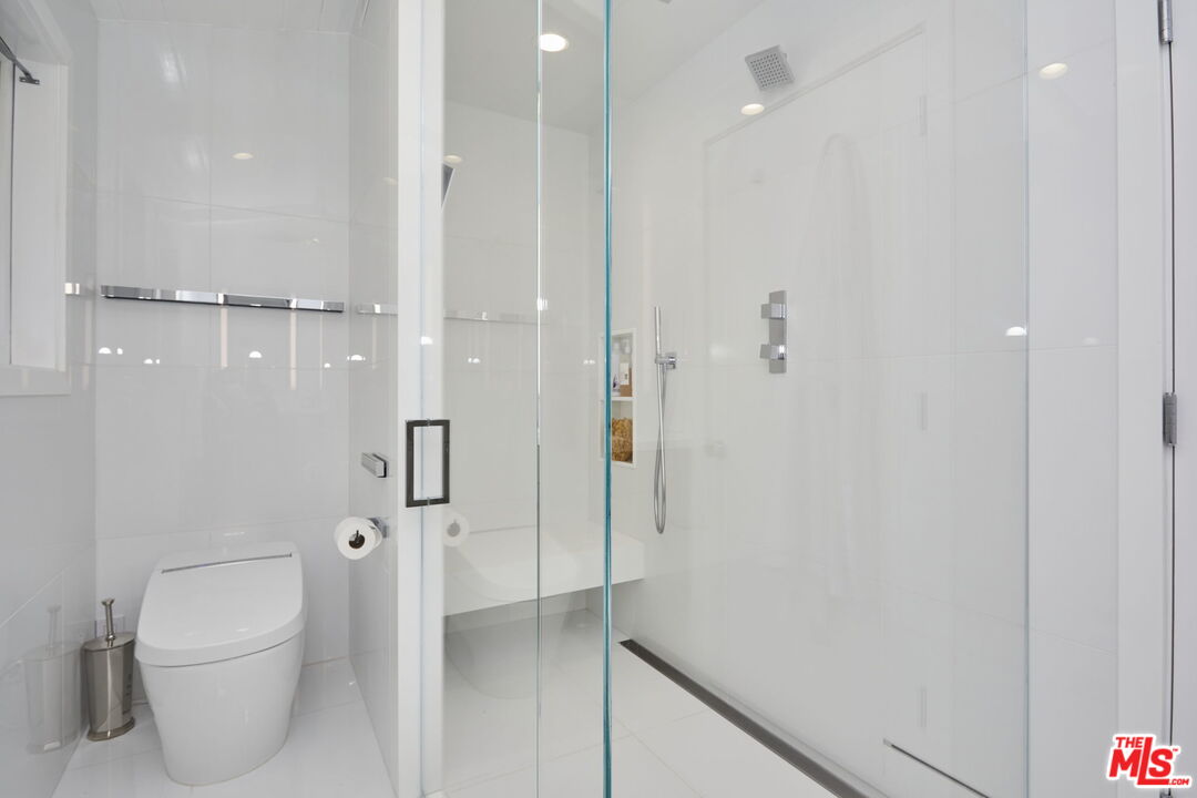 9428 Lloydcrest Drive Beverly Hills, CA 90210 - Photo 12 of 36 a bathroom with a shower and toilet