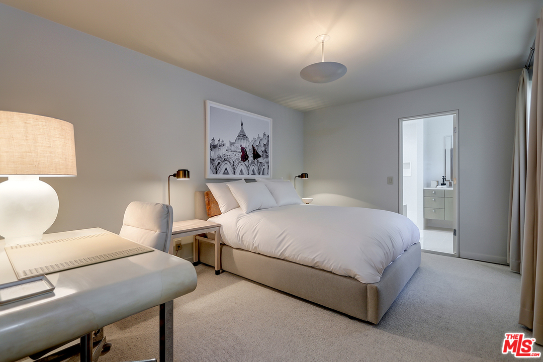 9428 Lloydcrest Drive Beverly Hills, CA 90210 - Photo 13 of 36 a spacious bedroom with a bed and a table