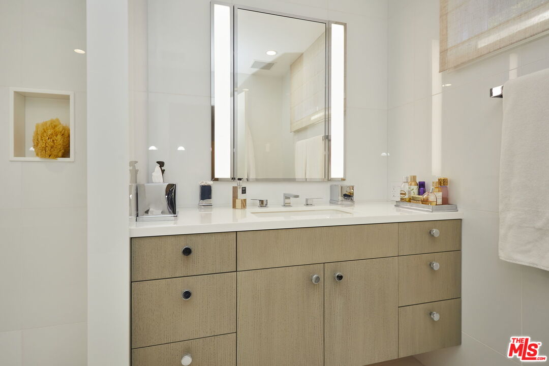 9428 Lloydcrest Drive Beverly Hills, CA 90210 - Photo 14 of 36 a bathroom with a sink vanity and mirror