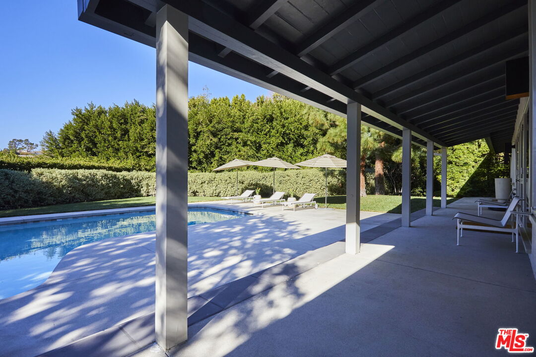 9428 Lloydcrest Drive Beverly Hills, CA 90210 - Photo 18 of 36 a view of a patio with table and chairs potted plants with wooden floor