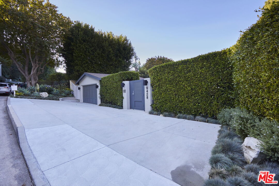 9428 Lloydcrest Drive Beverly Hills, CA 90210 - Photo 24 of 36 a view of a house with a yard and large trees