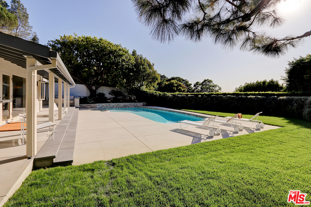 9428 Lloydcrest Drive Beverly Hills, CA 90210 - Photo 26 of 36 a view of swimming pool with a garden