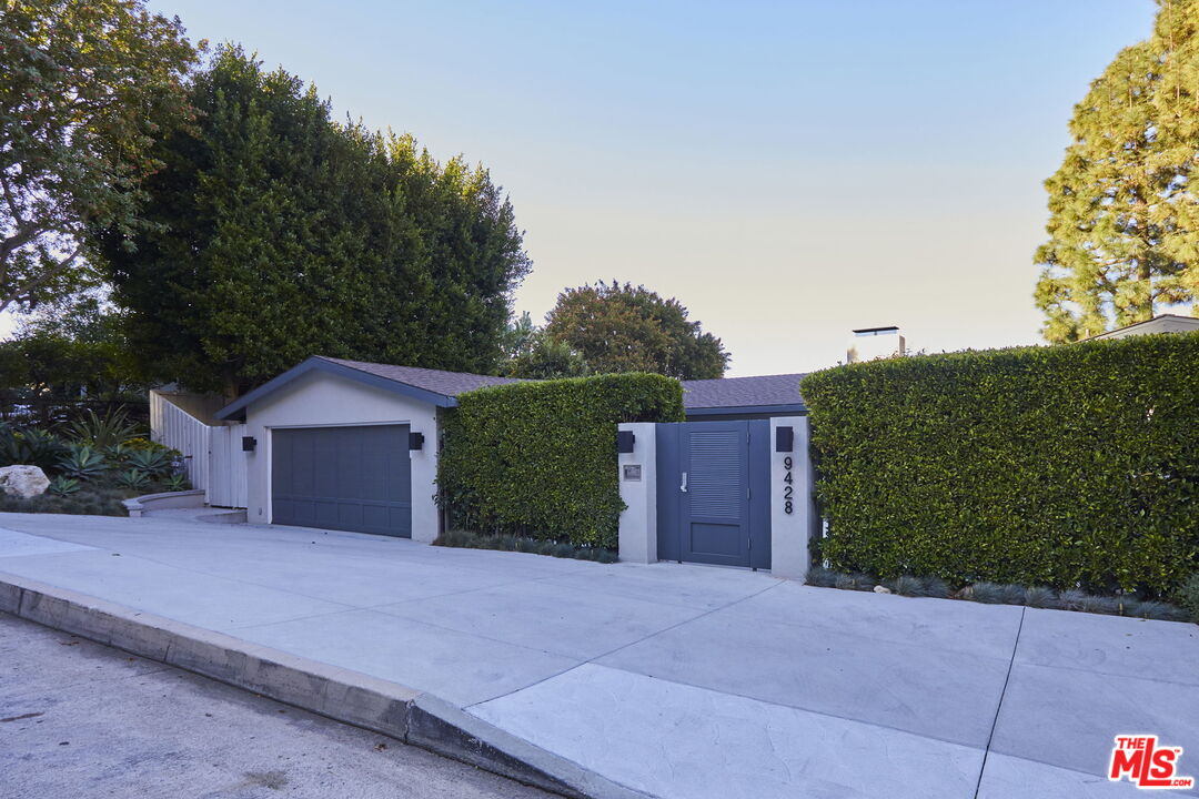9428 Lloydcrest Drive Beverly Hills, CA 90210 - Photo 36 of 36 a view of a house with a yard and plants