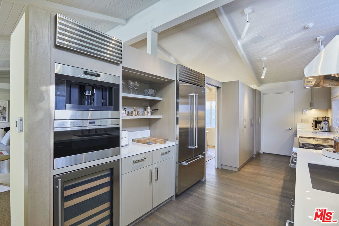 9428 Lloydcrest Drive Beverly Hills, CA 90210 - Photo 7 of 36 a kitchen with stainless steel appliances a stove and a refrigerator