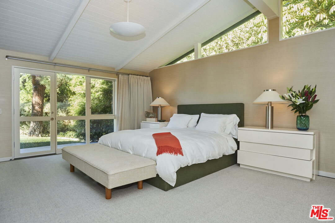 9428 Lloydcrest Drive Beverly Hills, CA 90210 - Photo 10 of 36 a bedroom with a bed lamp and window