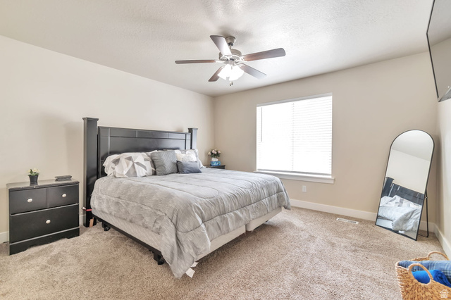 13038 Tower Ridge Drive Riverton, UT 84096 - Photo 13 of 30 Carpeted room featuring a ceiling fan with light fixture, window with blinds, and white baseboards