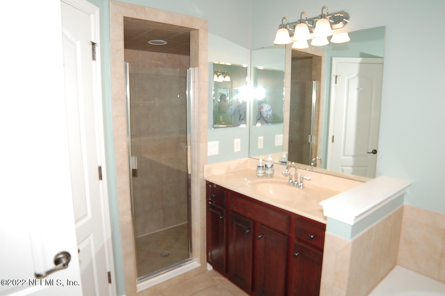 562 Candlebark Drive Jacksonville, FL 32225 - Photo 14 of 30 a bathroom with a sink vanity and a mirror