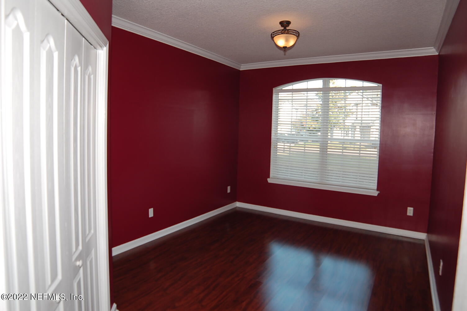 562 Candlebark Drive Jacksonville, FL 32225 - Photo 17 of 30 a view of an empty room with wooden floor and a window