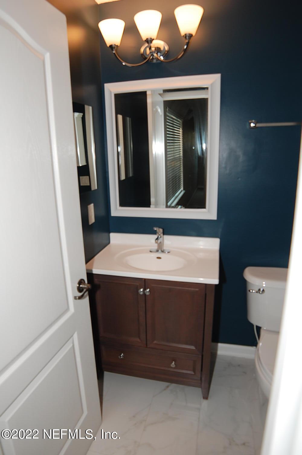562 Candlebark Drive Jacksonville, FL 32225 - Photo 25 of 30 a bathroom with a sink and a mirror