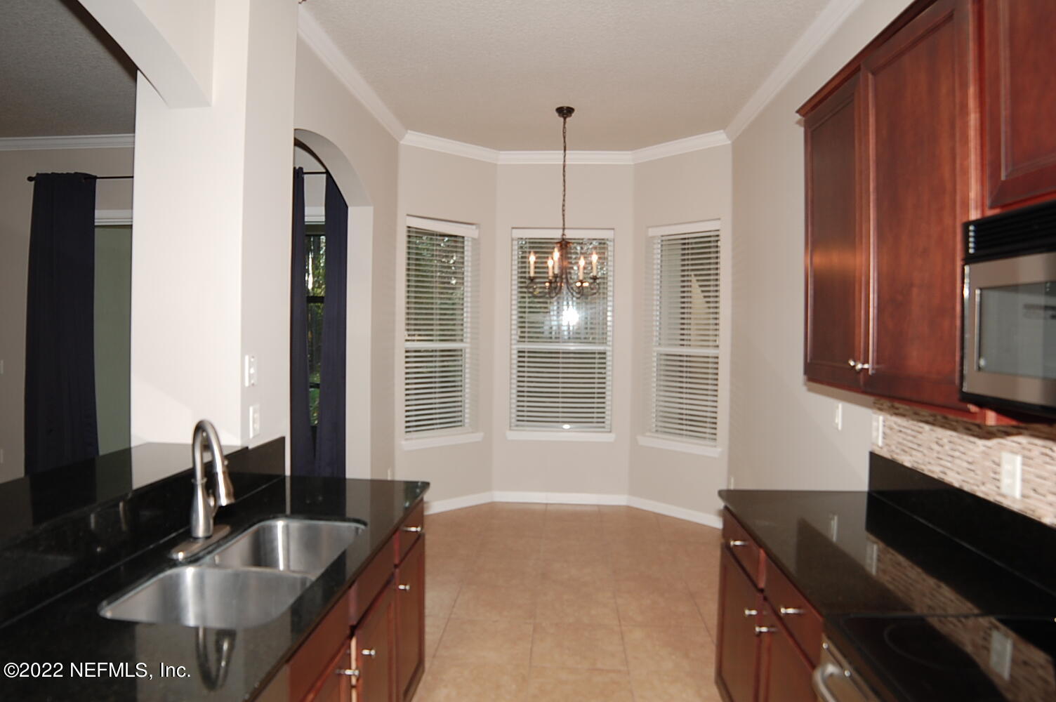 562 Candlebark Drive Jacksonville, FL 32225 - Photo 9 of 30 a kitchen with granite countertop a sink and a stove top oven
