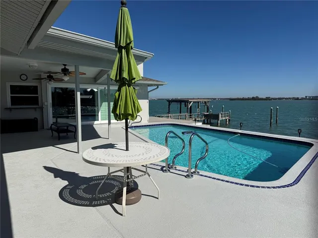 a view of a swimming pool with chairs