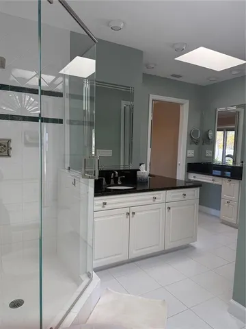 a bathroom with a double vanity sink and a mirror