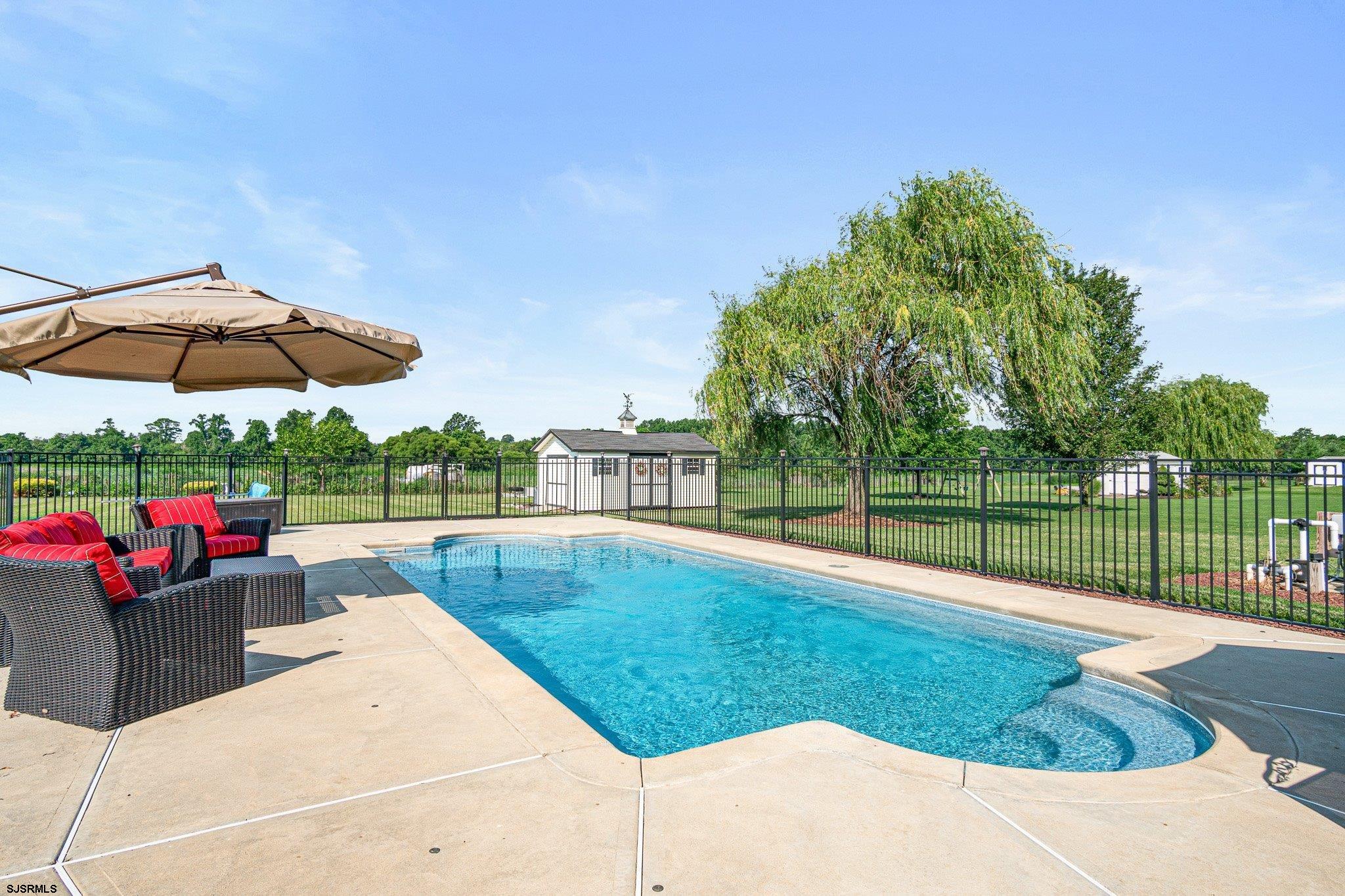 109 Quail Ridge Way Mickleton, NJ 08056 - Photo 12 of 59 a view of a backyard with sitting area and umbrella