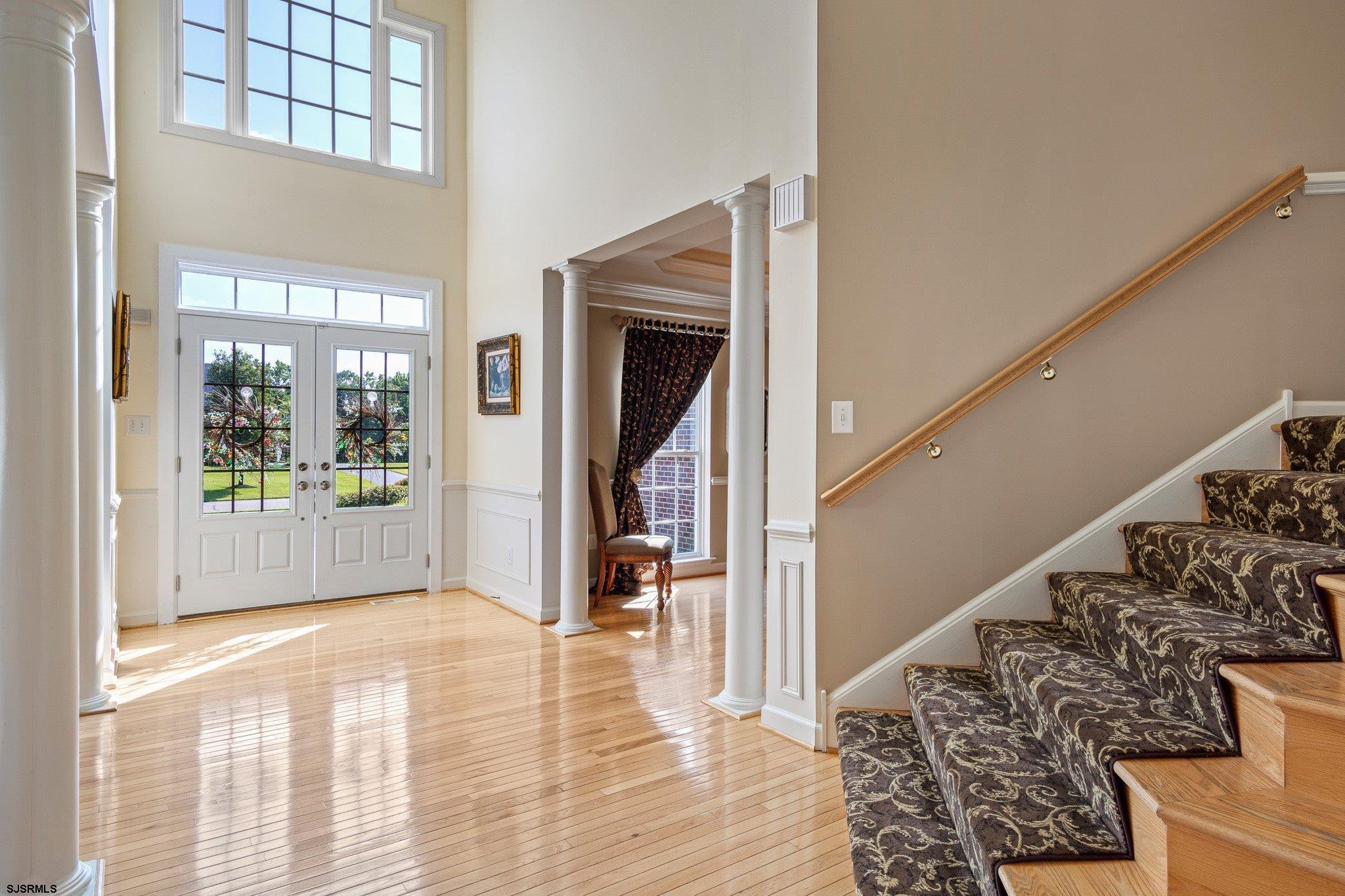 109 Quail Ridge Way Mickleton, NJ 08056 - Photo 27 of 59 a view of a hallway to a livingroom with wooden floor and a rug